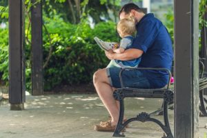 father reading with his child 